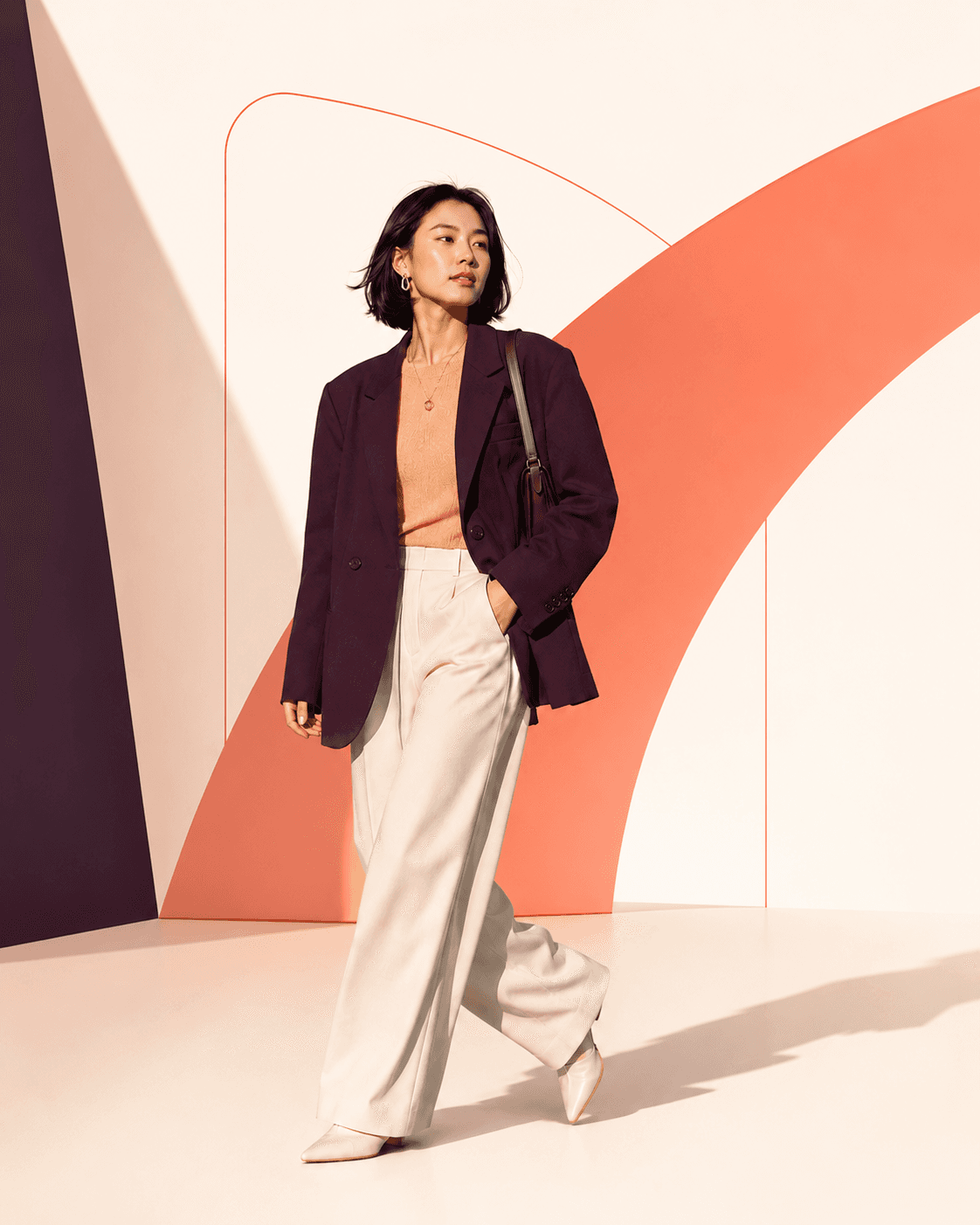 Fashion creator walking in an oversized blazer and wide-leg trousers