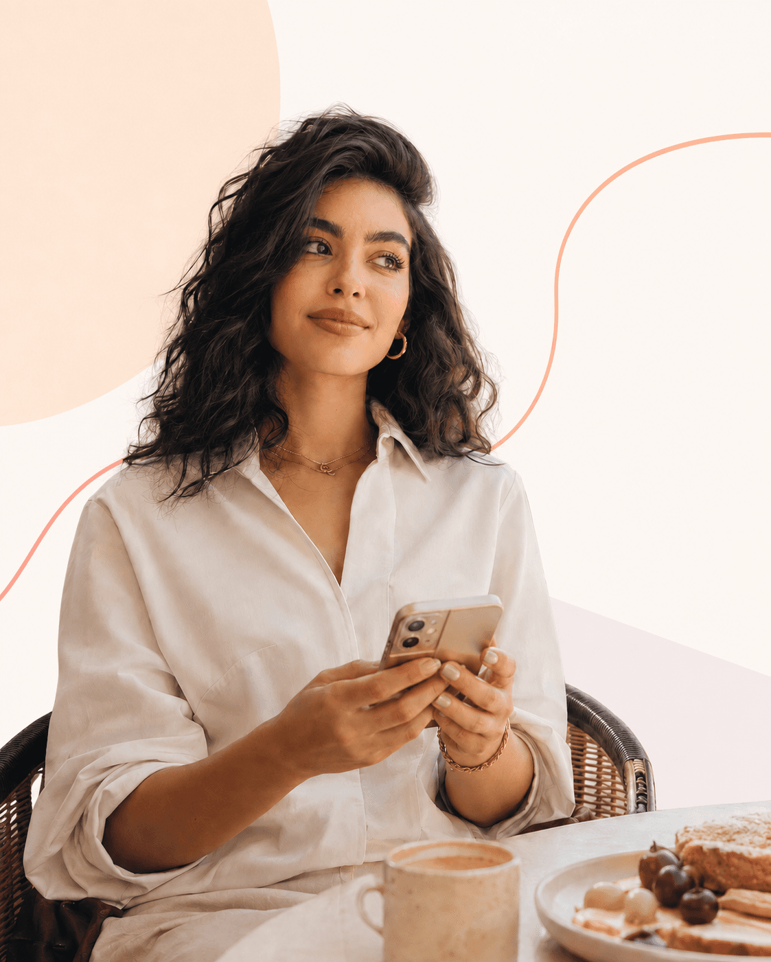 Lifestyle creator checking her phone at a café table, natural warm tones